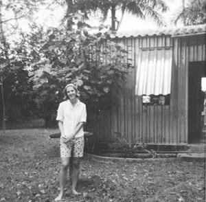 Old picture of Rita in front of house in D.R