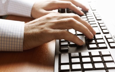Businessman typing on computer keyboard